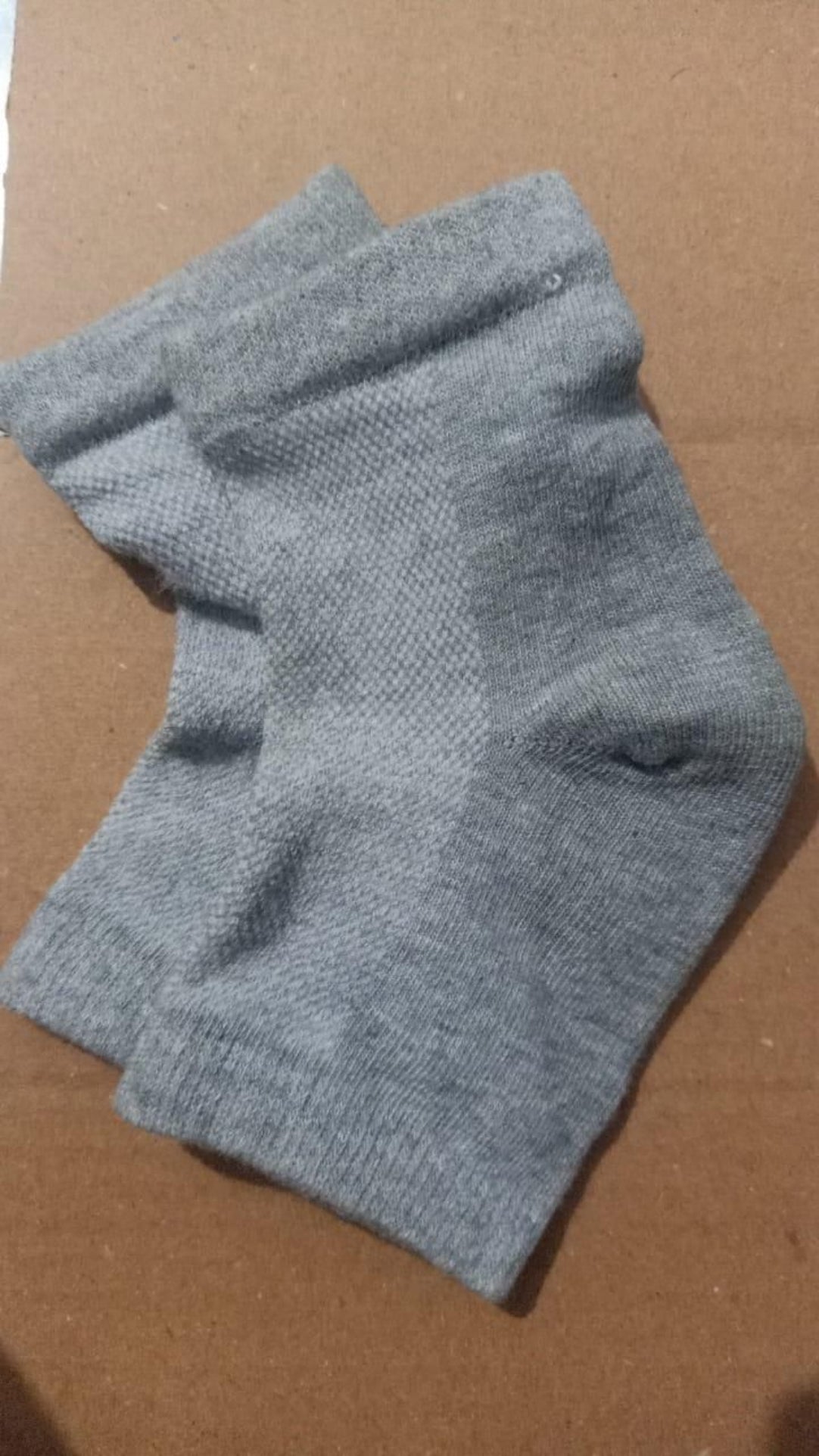 Gray sock on a brown cardboard background