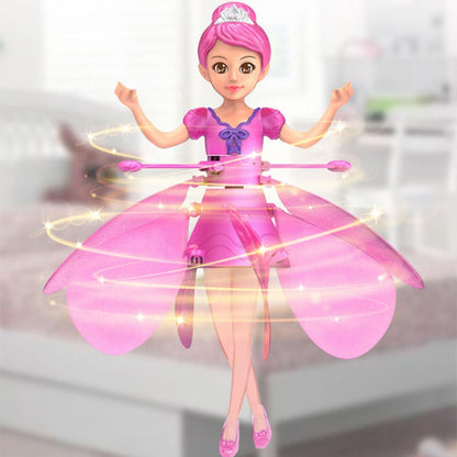 Toy doll with pink outfit and fairy wings on a blurred background