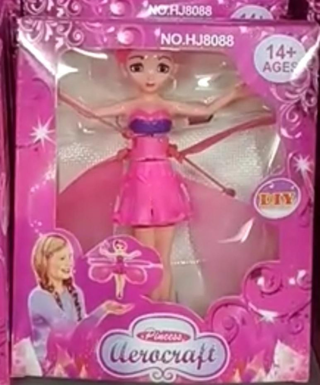 Toy doll in pink dress with 'Aerocraft' branding on a pink packaging background.