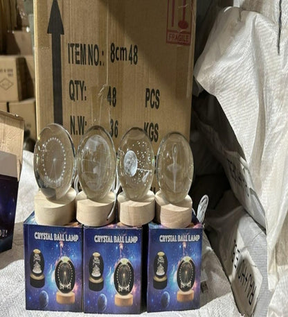 Crystal ball lamps with packaging on a cardboard box background
