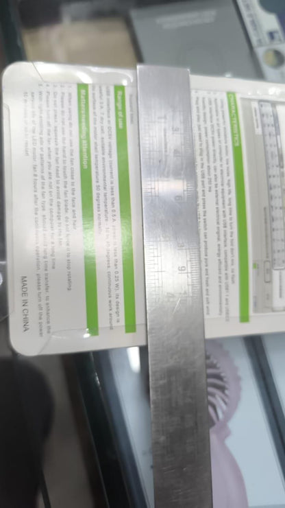 Metal ruler with measurement details on a blurred background