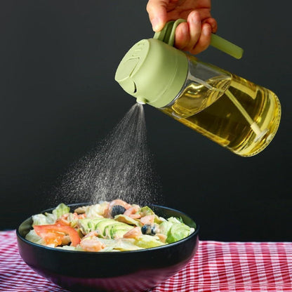 Person using a spray bottle to add dressing to a salad on a checkered tablecloth.