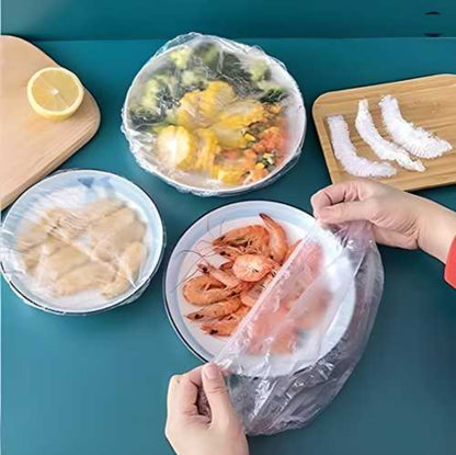 A person is stretching a white reusable elastic food storage plastic cover over a bowl containing food items, illustrating the use of the product.