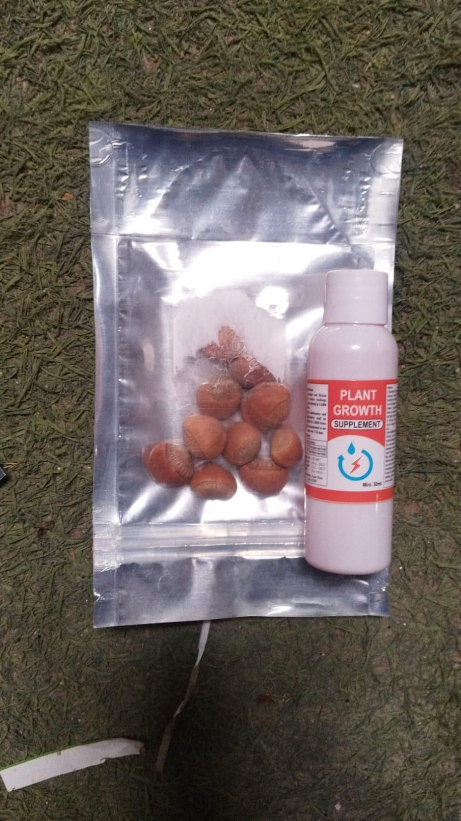 Silver packaging with plant seeds and a bottle labeled 'Plant Growth' on a textured green background