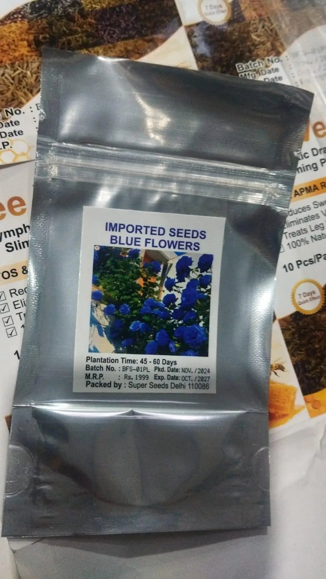 Seeds packet with blue flowers on a newspaper background