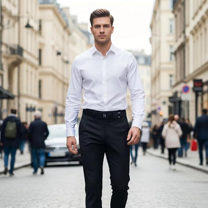 Man in a white shirt and black pants standing on a city street.