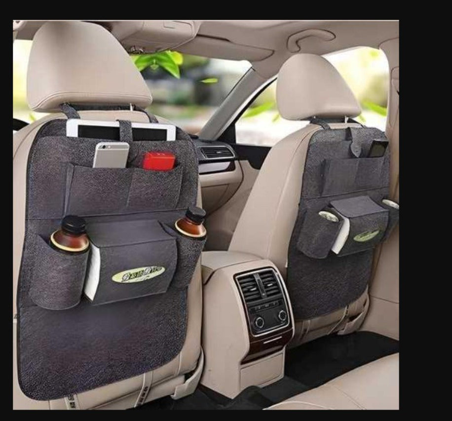 Car seat organizer with multiple pockets and a cup holder in a car interior.