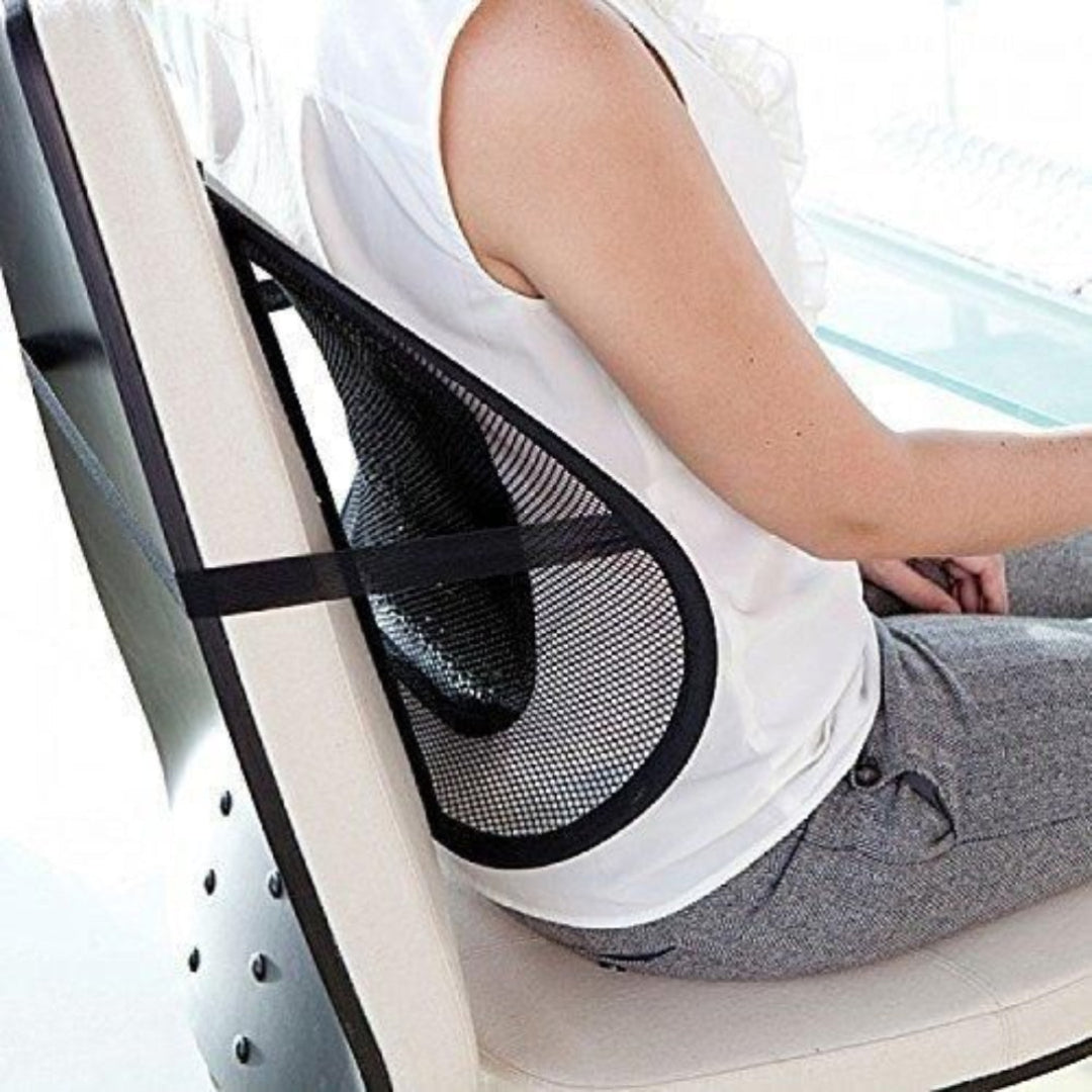 Person using a mesh back support on a chair