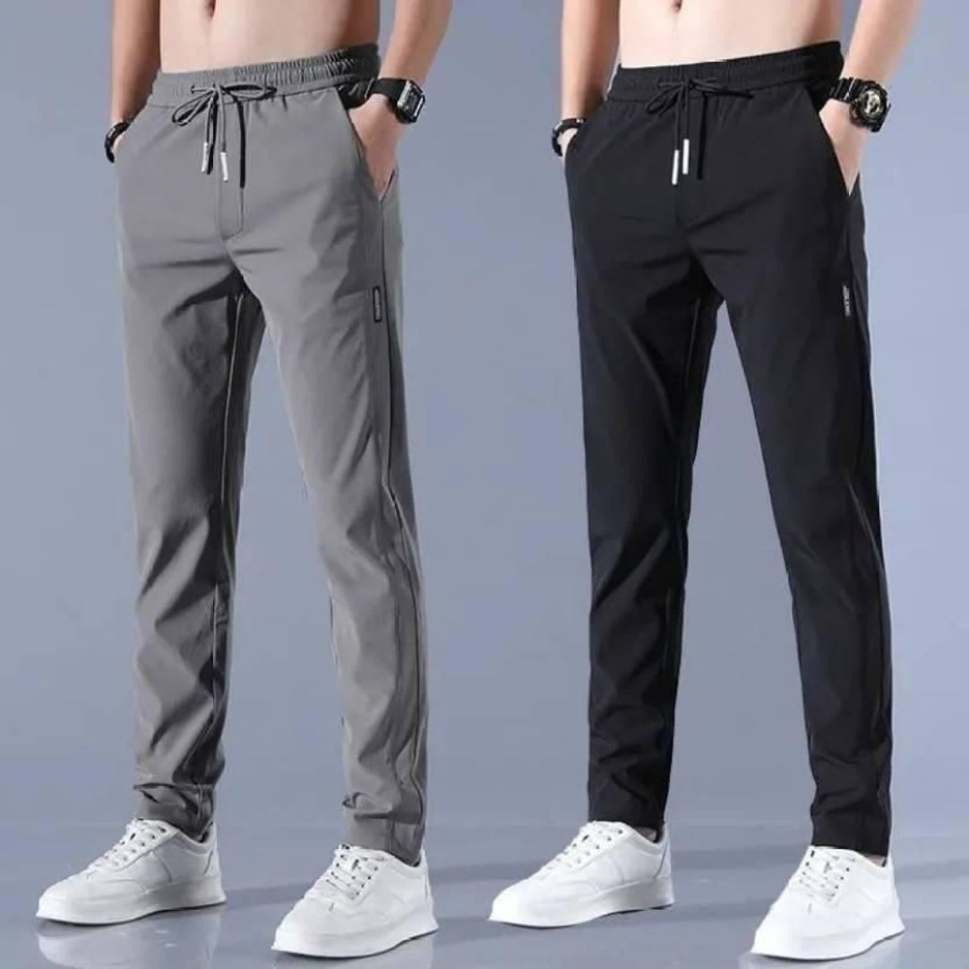 Two pairs of men's jogger pants, one gray and one black, on a plain background.