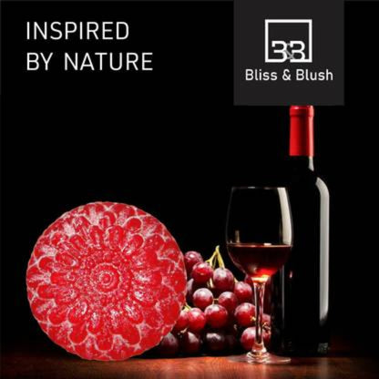 Wine bottle, glass, grapes, and red cheese with 'Bliss & Blush' branding on a dark background.
