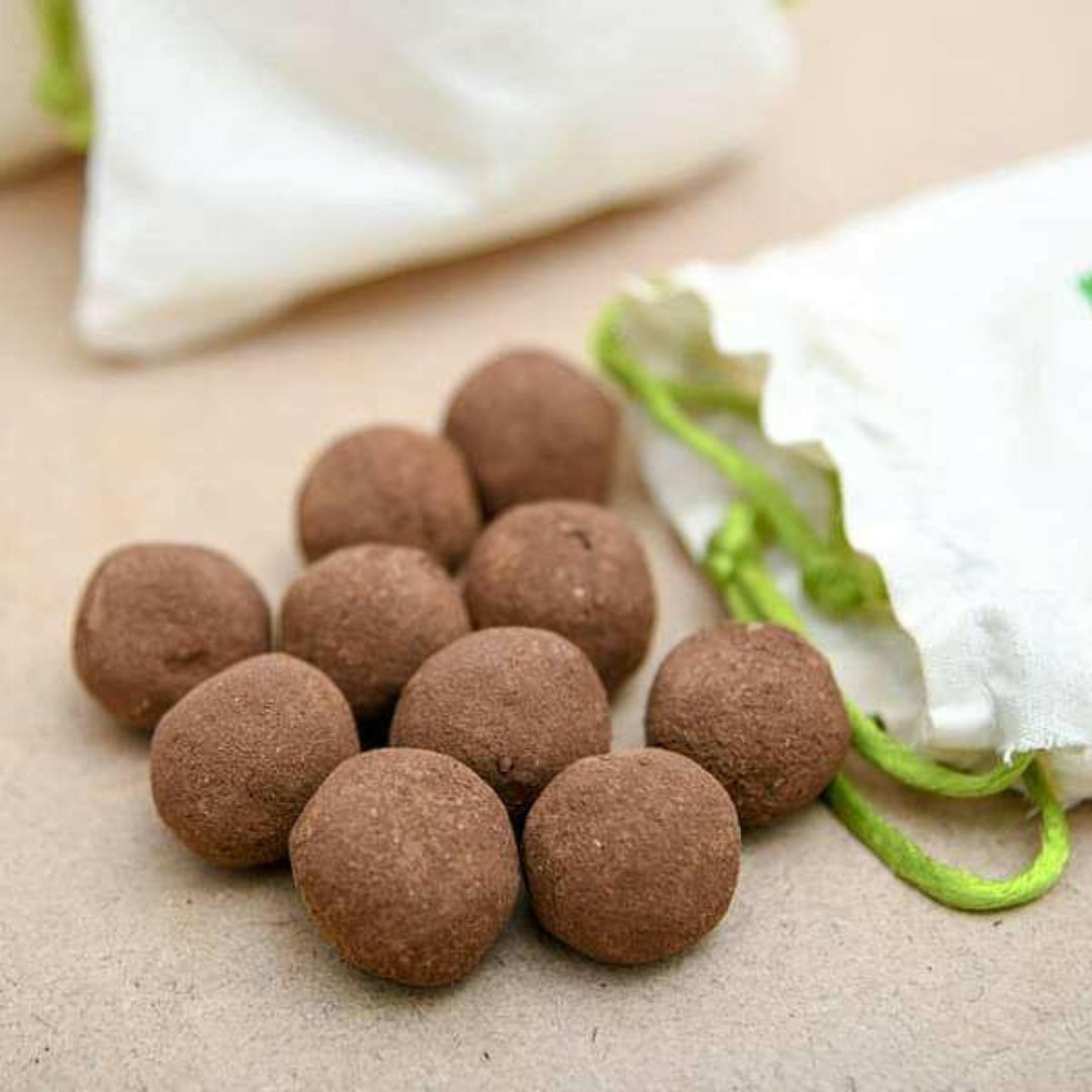 Brown spherical objects on a beige surface with white bags in the background
