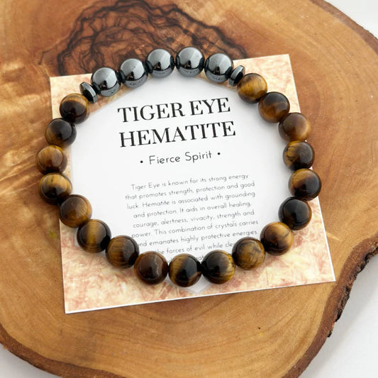 Tiger eye hematite bracelet on a wooden surface with descriptive card