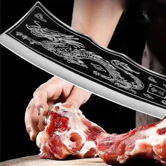 Person using a large cleaver to cut meat with a dragon design on the blade.