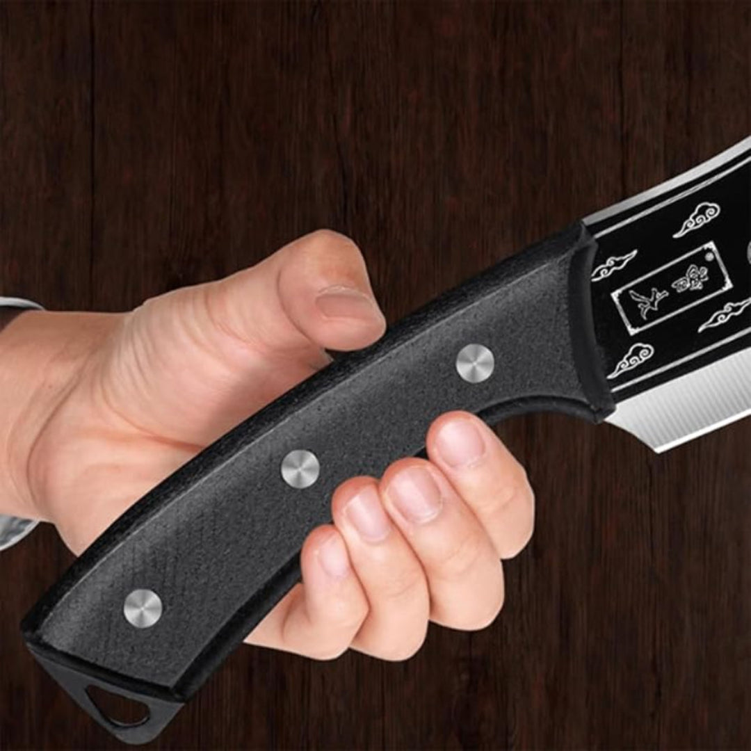 Hand holding a black folding knife with a dark wooden background