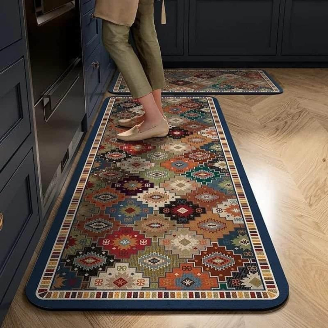 Colorful patterned rug on a wooden floor with a person standing on it.