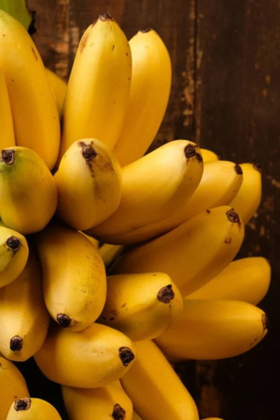 Bunch of yellow bananas with a dark background