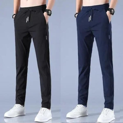 Two pairs of men's track pants, one pair in black and one pair in blue, both with drawstrings and side pockets.