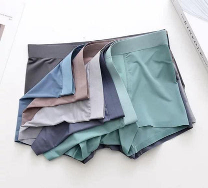 Stack of folded satin fabric swatches in various colors on a white background