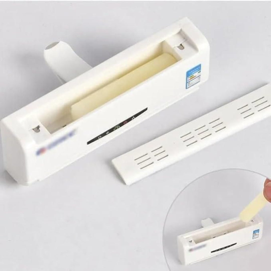 White plastic strip with a roll of tape on a gray background