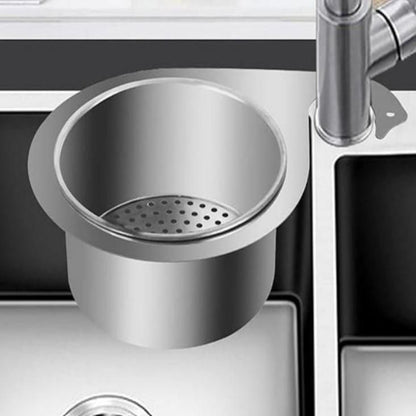 Stainless steel swan-shaped drain basket fitted into a kitchen sink, designed to catch food particles and prevent clogs.