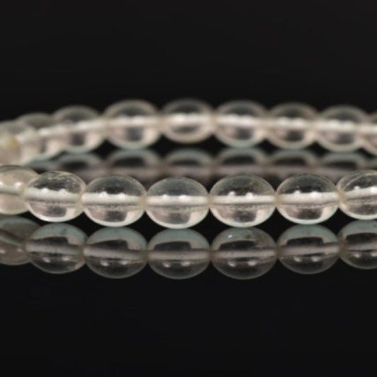 A stretch-fit, handmade bracelet made with high-quality quartz beads, displayed against a dark background.