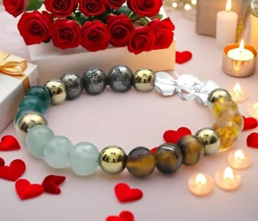 Colorful beaded bracelet with a silver clasp on a romantic setting with red roses and candles.