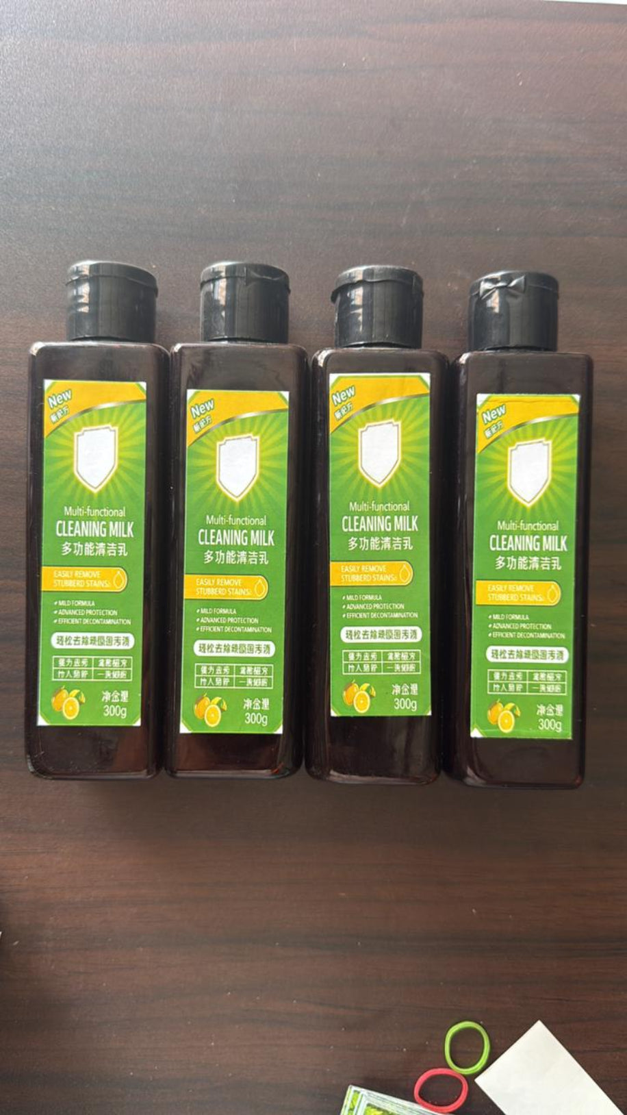 Four bottles of cleaning milk on a wooden surface