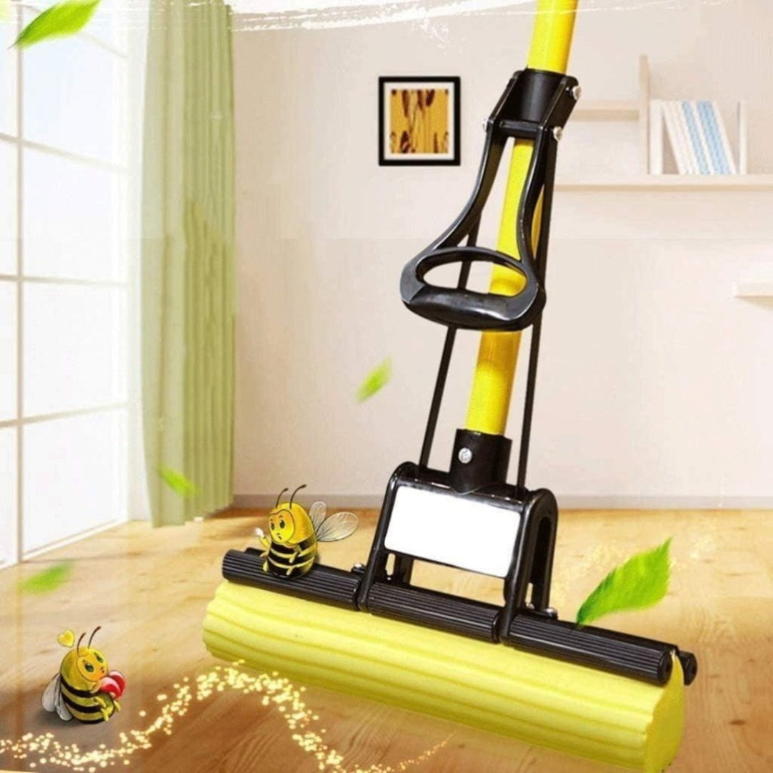 A yellow and black foldable squeeze mop with a microfiber pad, displayed in a home setting with bees as a decorative element in the background.