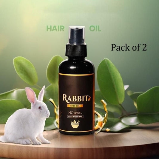 A bottle of Rabbit Hair Oil with a spray dispenser, accompanied by a white rabbit and set against a leafy backdrop. Text indicates a 'Pack of 2' offer.