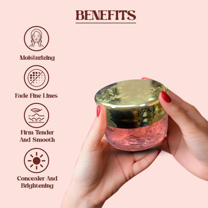 Hand holding a skincare product with benefits listed on a pink background