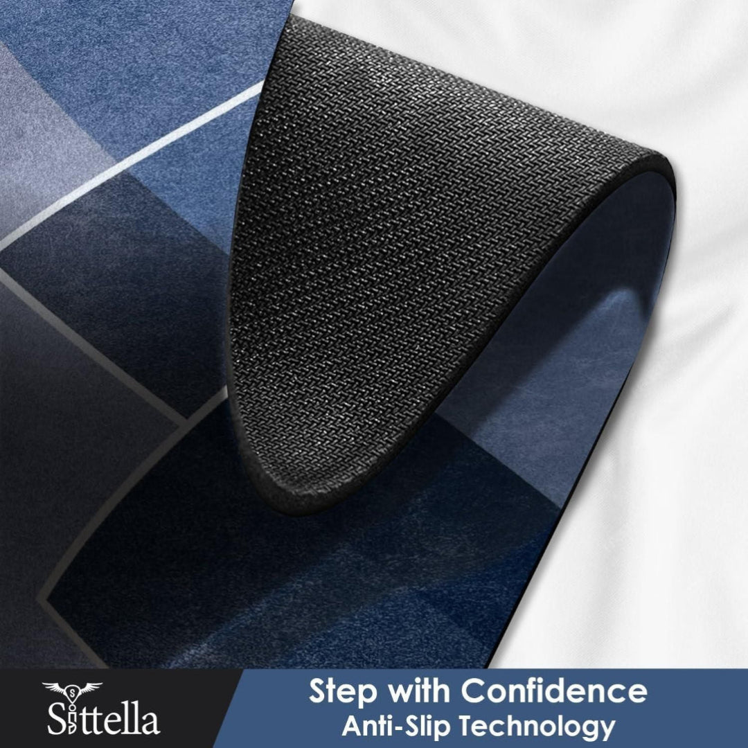 Black anti-slip mat on a textured surface with 'Sittella' branding and text.