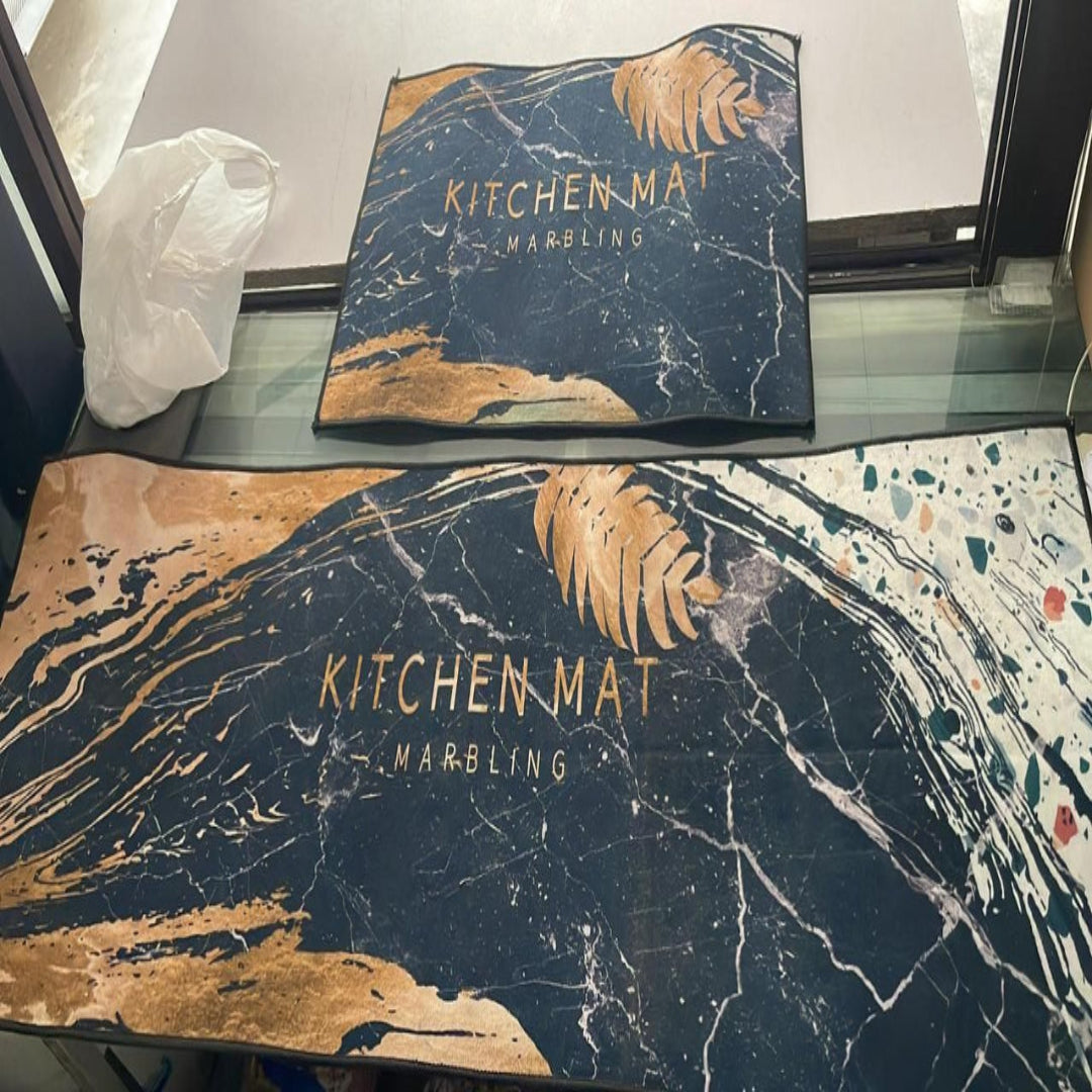 Two kitchen mats with marble design and 'Kitchen Mat' branding on a glass surface.
