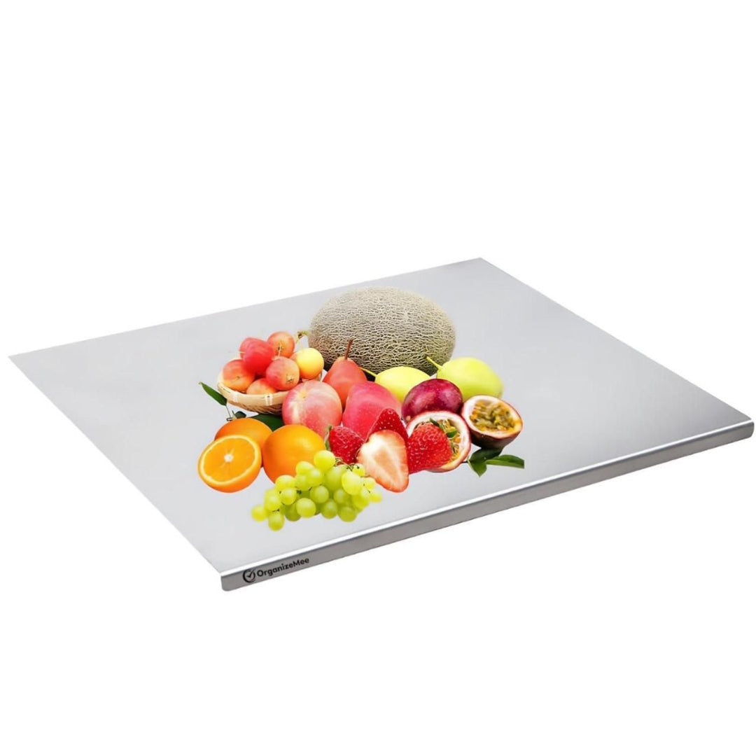 Fruit-themed glass cutting board on a white background