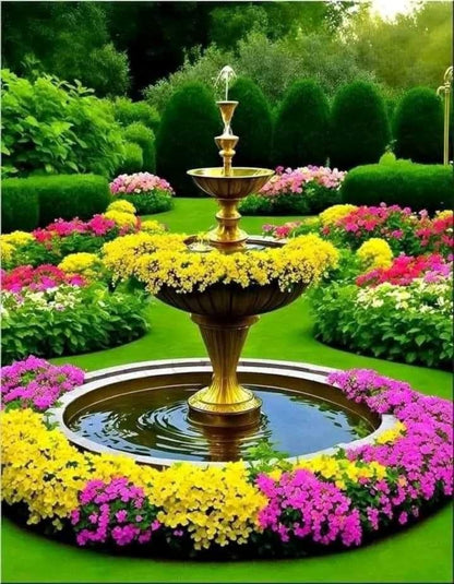 Decorative fountain surrounded by colorful flowers in a garden setting