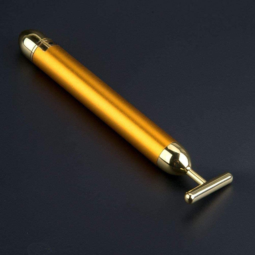 Gold pen with a metallic clip on a dark background