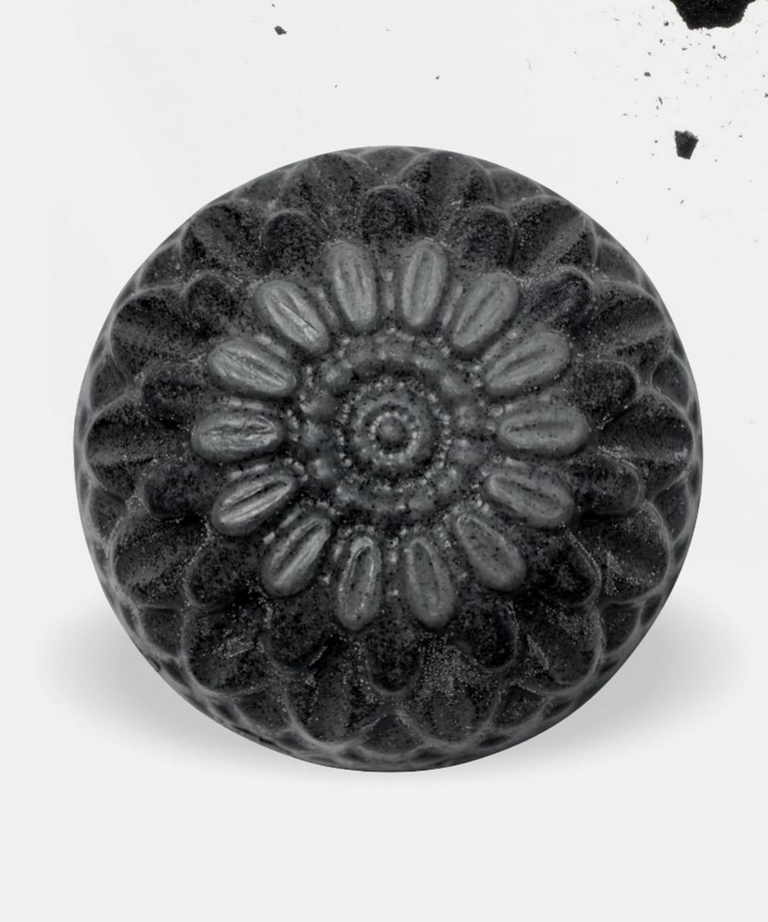 Black and white image of a decorative knob with floral pattern on a white background