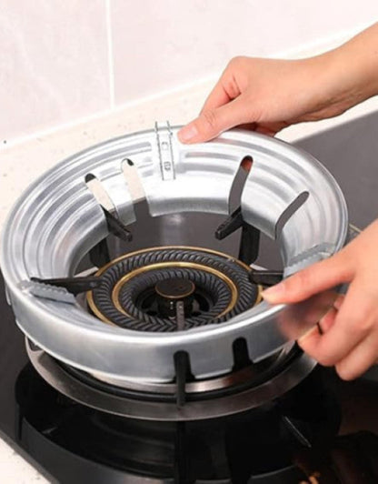 Person replacing a gas stove burner cover on a gas stove.