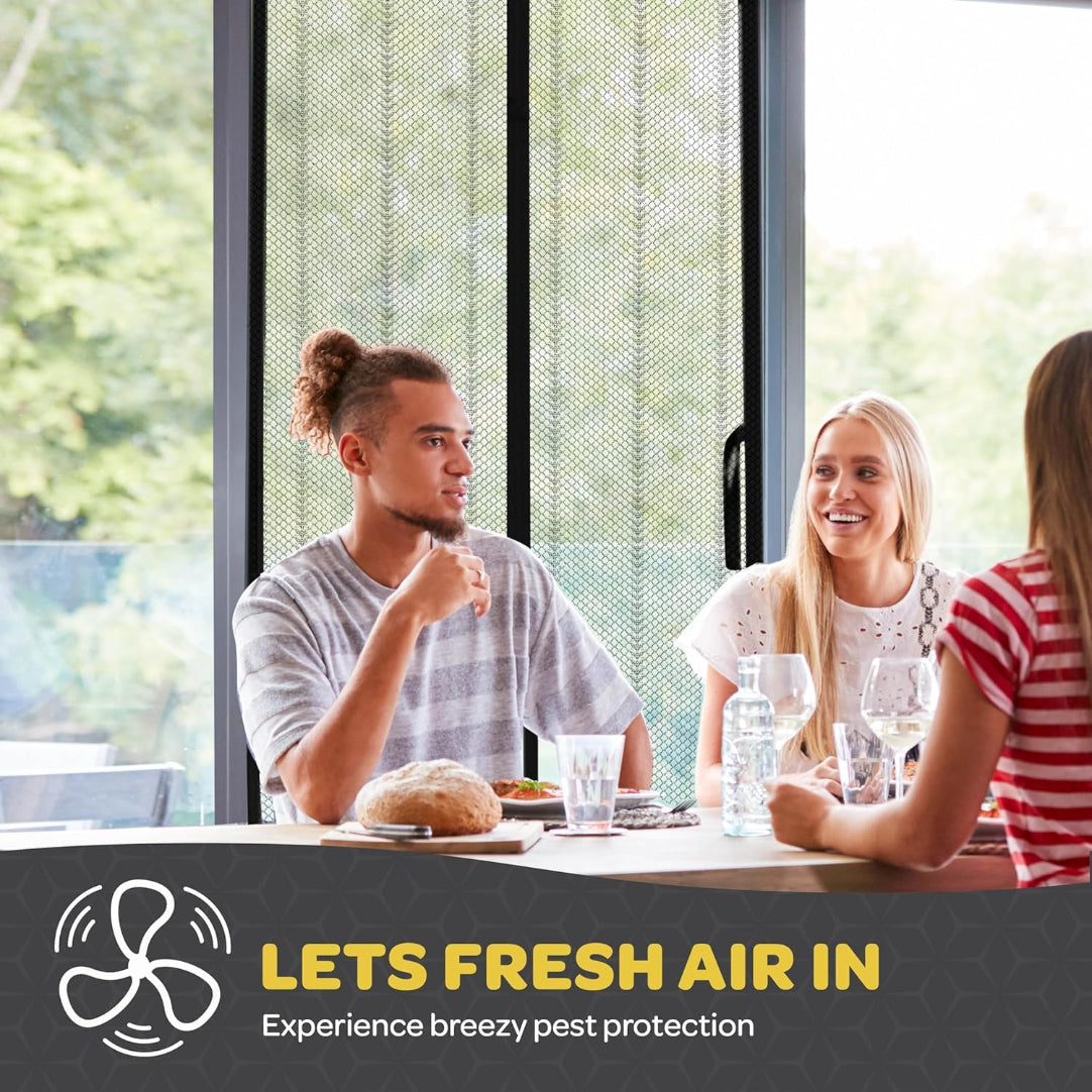 Three people sitting at a table with a 'Lets Fresh Air In' pest control advertisement.