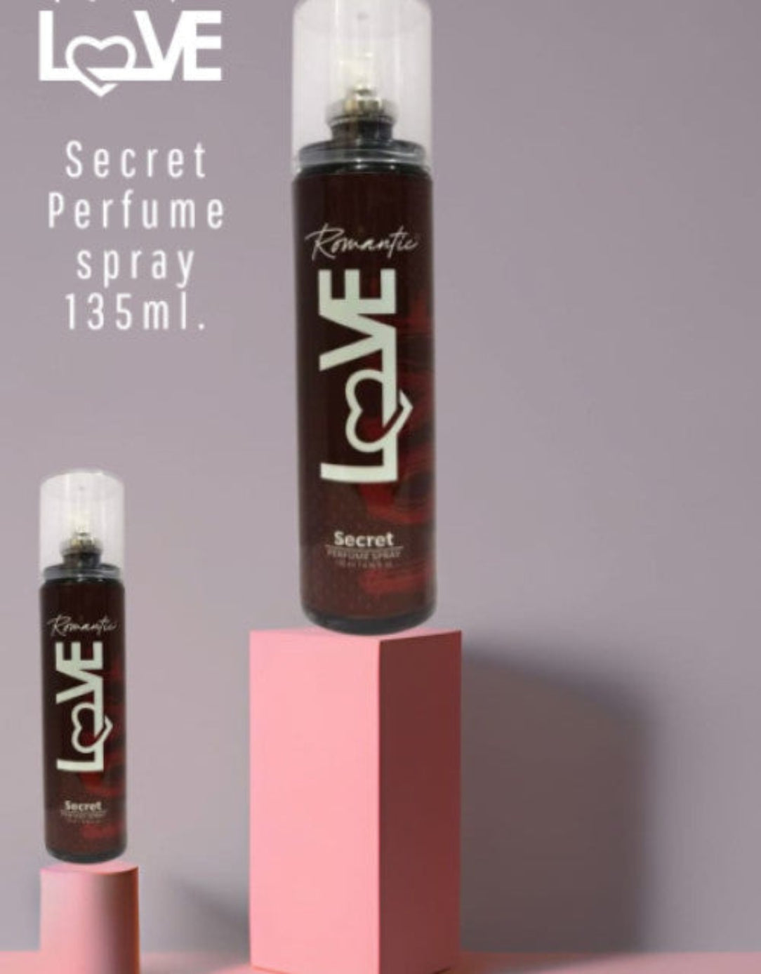 Two 'LOVE' perfume spray bottles on a gray background
