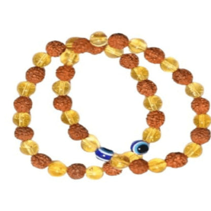 Two beaded bracelets with a blue evil eye charm on a white background