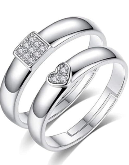 A set of silver-plated adjustable couple rings, featuring cubic zirconia studs, designed for engagements, weddings, and anniversaries.