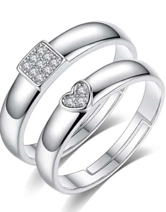 A set of silver-plated adjustable couple rings, featuring cubic zirconia studs, designed for engagements, weddings, and anniversaries.